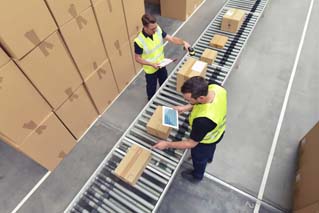 Trabajador en un almacén en los paquetes de procesamiento del sector logístico