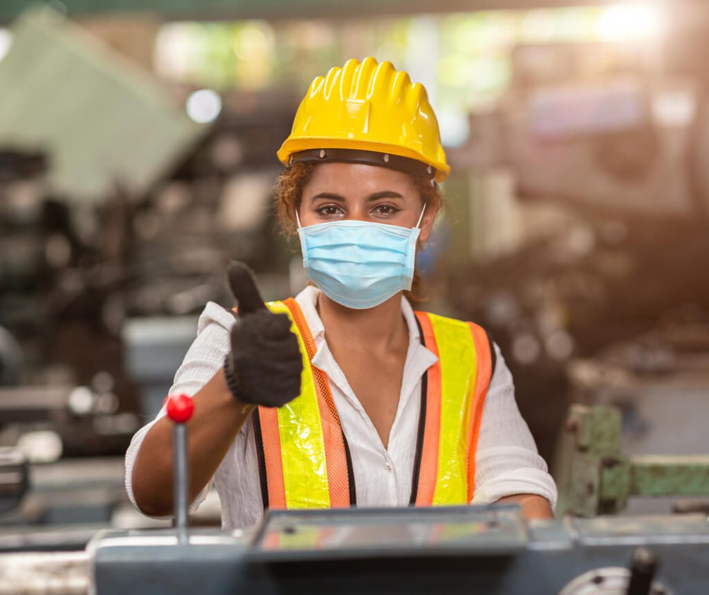Woman worker wearing disposable face mask for protection from Corona Virus